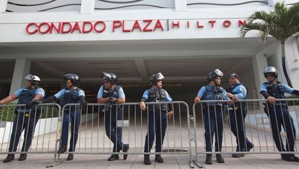 Police stand guard at the entrance of the Condado Plaza Hilton, at which the first seminar of the Puerto Rico Oversight, Management and Economic Stability Act (PROMESA) is scheduled to be held.