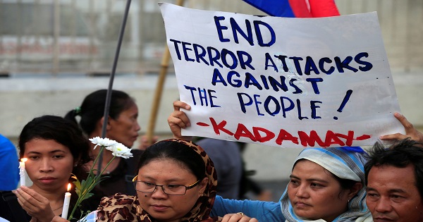 A woman holds a placard condemning the bombing at a market in Davao city, Manila, Philippines September 3, 2016.