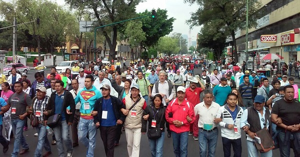 Striking teachers and their supporters march through the streets of Mexico City against Mexico's President Enrique Pena Nieto’s fourth government annual report to the congress, Sept. 1, 2016.