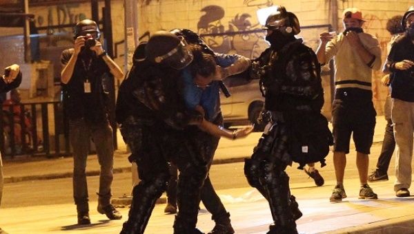A man is detained by riot police during a protest against Brazil's President Michel Temer in Sao Paulo, Brazil, September 4, 2016.