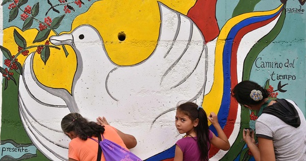 A peace mural is painted near the road leading to Planadas, Colombia, where a peasant uprising in 1964 led to the birth of the FARC.