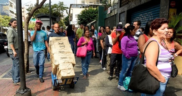 People stand in line to purchase goods in Venezuela.