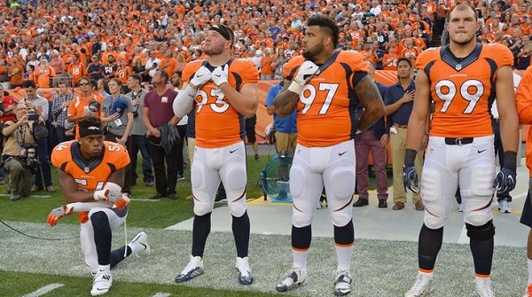Denver Broncos linebacker Brandon Marshall (54) kneels during the national anthem next to teammates before their game at Sports Authority Field at Mile High, Sept. 8, 2016.