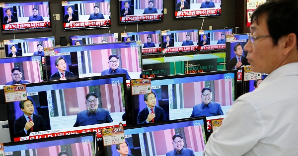 A sales assistant watches TV sets broadcasting a news report on North Korea's fifth nuclear test, in Seoul, South Korea, September 9, 2016.