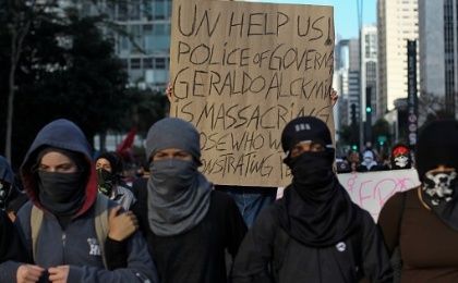 Demonstrators, holding a sign denouncing police repression, protest against Michel Temer in Sao Paulo, Brazil, September 7, 2016.