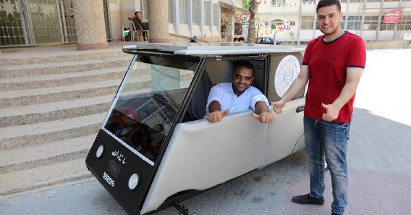 Khalid al-Bardawil and Jamal al-Miqat, engineering students at the Al-Azhar University, pose with their vehicle.