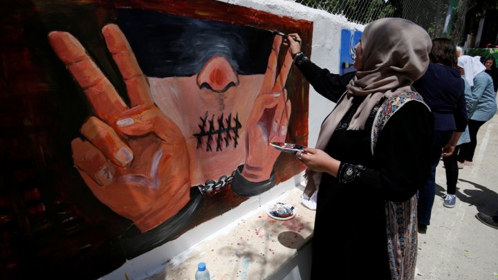 Palestinian women paint murals marking Palestinian Prisoner Day in the West Bank city of Ramallah, April 17, 2016.