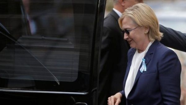Clinton gets into her van outside her daughter Chelsea's home in New York after she left ceremonies commemorating the 15th anniversary of the September 11 attacks feeling 'overheated.'