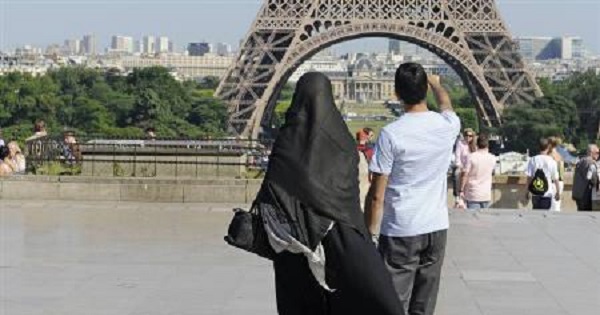A woman wearing a niqab walks at Trocadero square near the Eiffel Tower in Paris June 24, 2009.