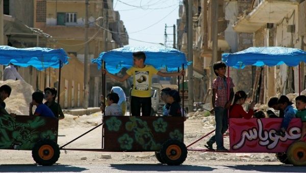 Children ride in carts on the third day of Eid al-Adha in the rebel-controlled city of Idlib, Syria Sept. 14, 2016. 