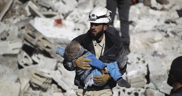 A civil defence member carries a dead child in a site hit by airstrikes in the rebel-controlled area of Maaret al-Numan town in Idlib province, Syria.