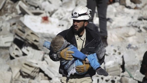 A civil defence member carries a dead child in a site hit by airstrikes in the rebel-controlled area of Maaret al-Numan town in Idlib province, Syria. 