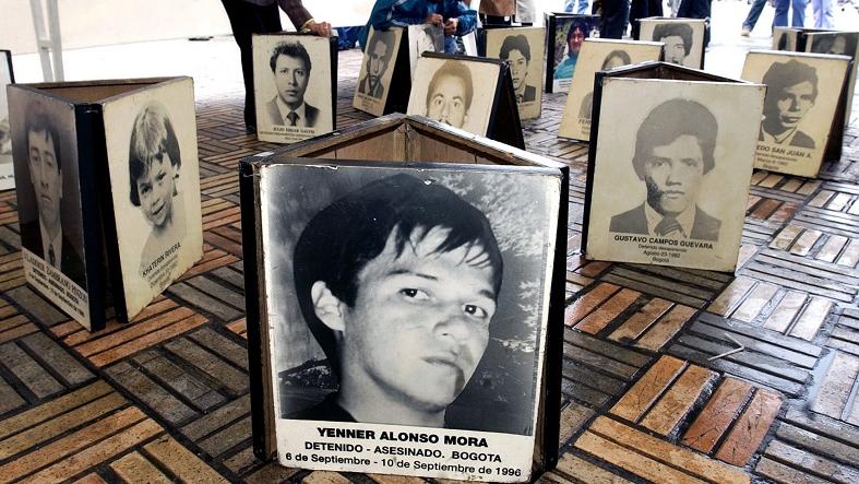 Photos of forcibly disappeared supporters of the Patriotic Union are displayed as part of the “Gallery of Memory” in Bogota, Colombia, Aug. 9, 2004.
