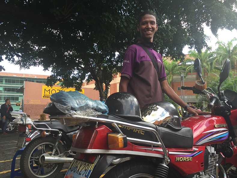 19 year-old Jahir has been working as the manager of a motorcycle taxi service outside of a Caracas mall for a year now. 