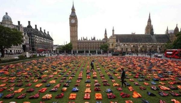 A display of life jackets worn by refugees during their crossing from Turkey to Greece are seen in Parliament Square in the U.K., Sept. 19, 2016.