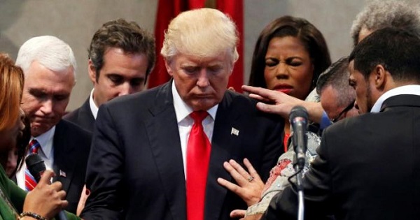 Members of the clergy lay hands and pray over Donald Trump at the New Spirit Revival Center in Cleveland Heights, Ohio.