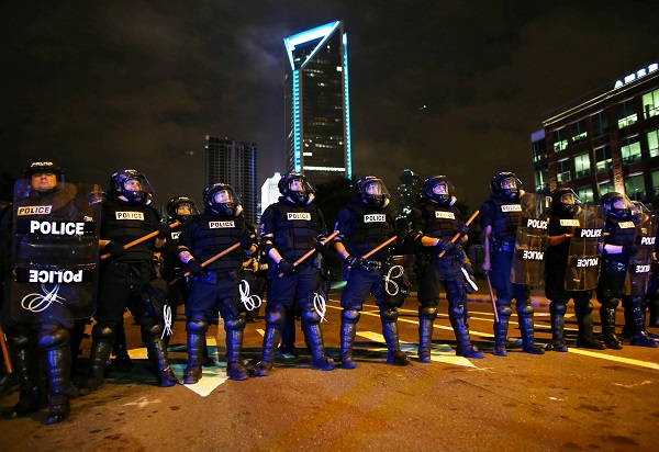 Riot police prepare to push protesters off the highway during another night of protests over the police shooting of Keith Scott in Charlotte, North Carolina, U.S. September 22, 2016.