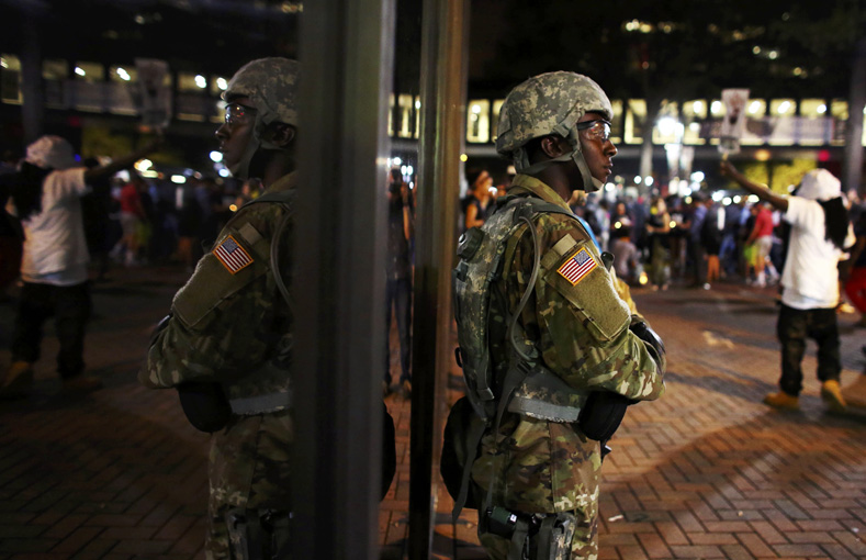  A member of the National Guard stands guard during another night of protests over the police shooting of Keith Scott in Charlotte, North Carolina, Sept. 22, 2016.