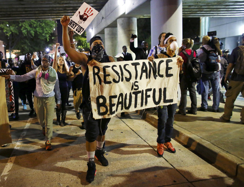 Protesters walk in the streets downtown during another night of protests over the police shooting of Keith Scott in Charlotte, North Carolina, U.S. Sept. 22, 2016.