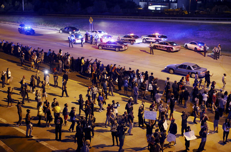 Protesters head onto the highway during another night of protests over the police shooting of Keith Scott in Charlotte, North Carolina, Sept. 22, 2016. 