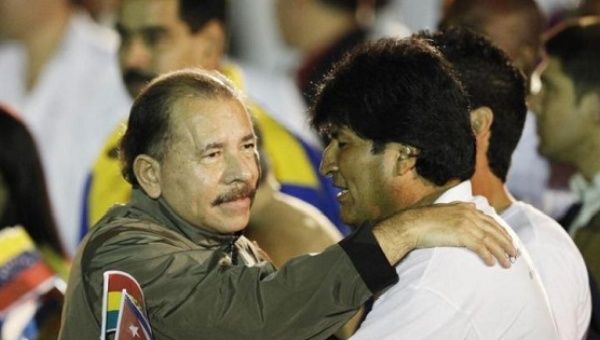 Nicaragua's President Daniel Ortega (L) hugs his Bolivian counterpart Evo Morales before the march of the torches in celebration of the 161th birth anniversary of Cuba's independence hero Jose Marti in Havana January 27, 2014.