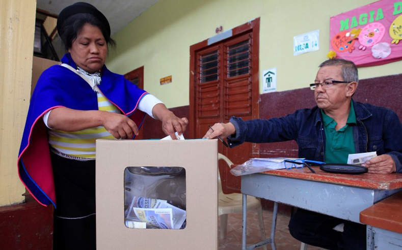 A Colombian Guambiano indigenous woman votes in a referendum on a peace deal between the government and Revolutionary Armed Forces of Colombia (FARC) rebels in Silvia, Colombia, Oct. 2, 2016.