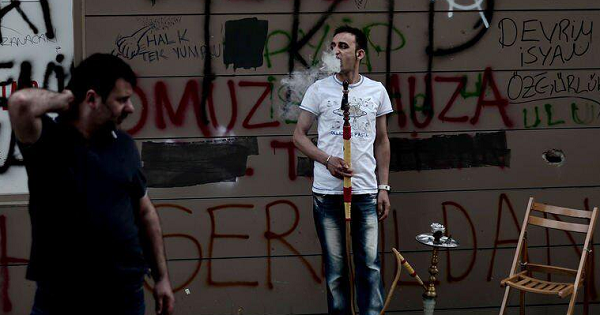 A man smokes shisha near Taksim square in Istanbul, Turkey.