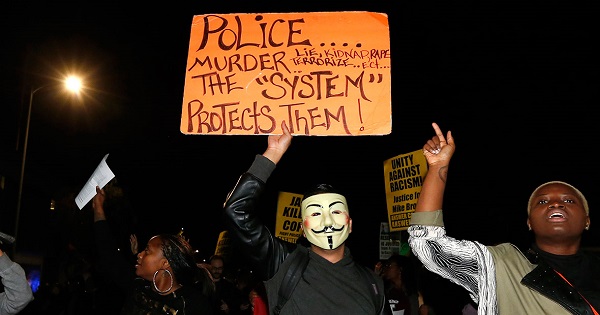 People chant and hold up protest signs during a demonstration in Los Angeles, California.