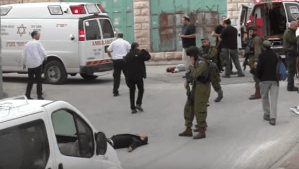 Israeli soldier Elor Azaria aims at wounded Palestinian man as he lies on the ground despite posing no threat.
