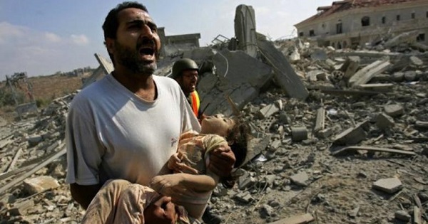 A man carries the body of a young girl killed in an Israeli bomb attack on Qana, South Lebanon, on July 30, 2006.