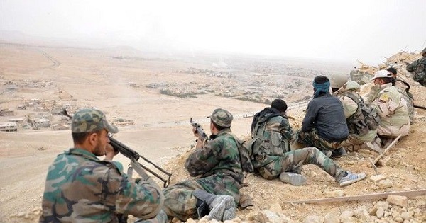 Forces loyal to Syria's President Bashar Assad take positions on a look-out point overlooking the historic city of Palmyra in Homs Governorate.