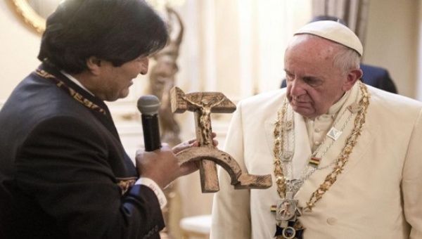 Bolivian President Evo Morales hands Pope Francis a communist cross - a cross embedded with a hammer and sickle.