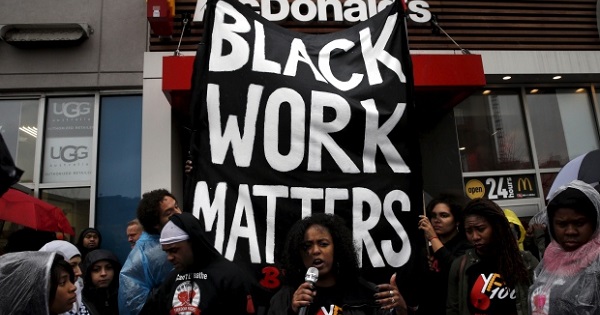 Fast-food workers in Harlem, N.Y., protest for a raise of the minimum wage.