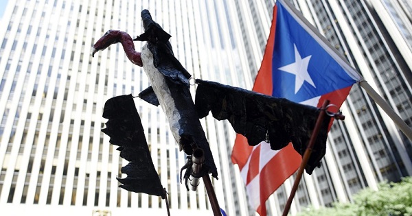 A vulture puppet is held at a protest against Puerto Rico's credit holders as a symbol of the so-called vulture funds.