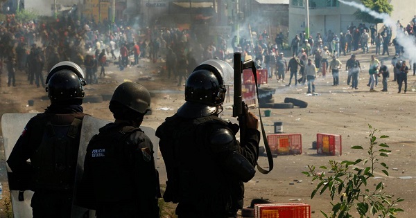 Riot police attack striking teachers in the town of Nochixtlan, in Oaxaca, Mexico, on Sunday.