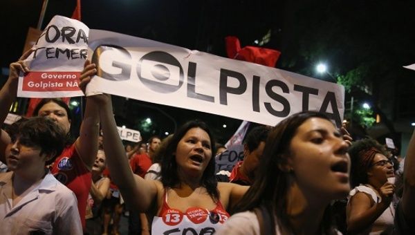 Supporters of Brazil's suspended President Dilma Rousseff, show a banner that reads 