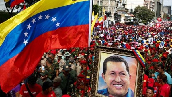 Supporters of Venezuela's President Nicolas Maduro hold a portrait of Venezuela's late president Hugo Chavez during a rally against imperialism in Caracas.