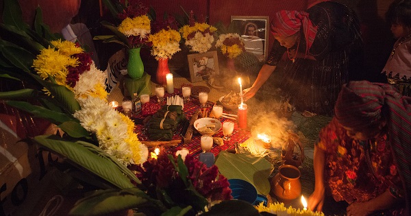 Local Q'eqchi' Mayan elders carry out a Mayan spiritual ceremony inside Angelica Choc’s home.