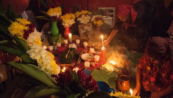 Local Q'eqchi' Mayan elders carry out a Mayan spiritual ceremony inside Angelica Choc’s home.
