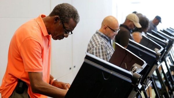 Voters cast ballots during early voting at the Beatties Ford Library in Charlotte, North Carolina Oct. 20, 2016.