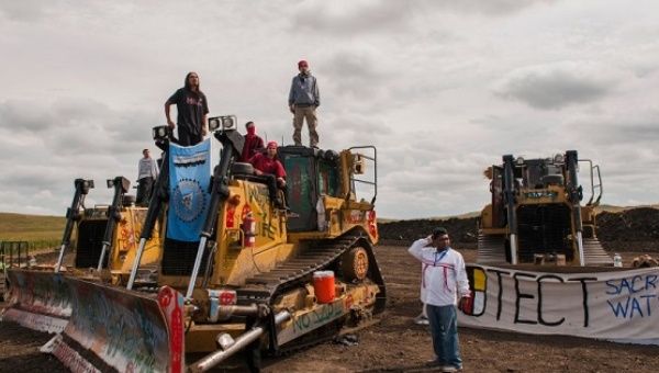 Protesters stand on machinery after halting work on the Dakota Access pipeline near the Standing Rock Sioux reservation, North Dakota, Sept. 6, 2016. 