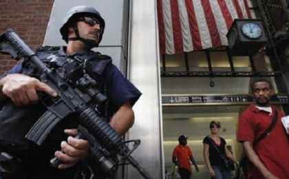Members of the public react as they walk past an NYPD Hercules team on patrol near Penn Station in New York City.