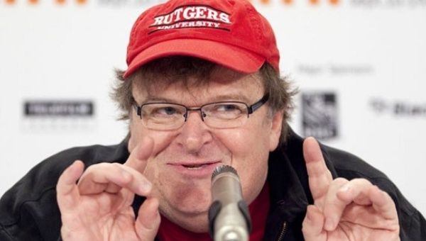 Documentary filmmaker Michael Moore has endorsed Bernie Sanders, saying the U.S. is ready for a socialist president. 