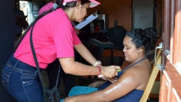 A health worker sprays mosquito repellent on a pregnant woman during a campaign to fight the Zika virus, Colombia, Feb. 1, 2016. 