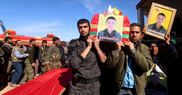 Relatives and fighters from the Kurdish People's Protection Units (YPG) carry the coffins of fellow fighters in the countryside of the town of Derbasiyeh, Syria.
