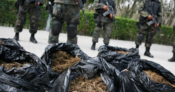 Soldiers stand guard next to bags of marijuana at a military base near Monterrey, Mexico, where the war on drugs has caused a massive increase in violence.