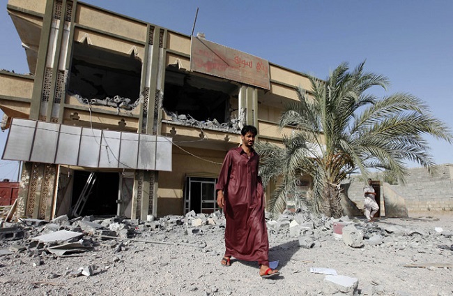 A man walks past the premises of a transport company which the Libyan government said was destroyed by NATO air strikes in Zliten, about 150km (93.2 miles) east of Tripoli July 21, 2011. 