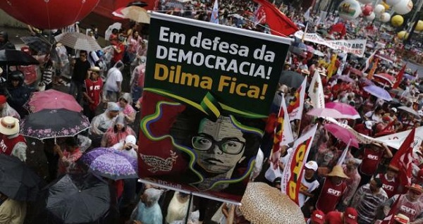 A pro-government demonstrator holds a banner with an image depicting Brazil's President Dilma Rousseff during a protest in Sao Paulo March 13, 2015.