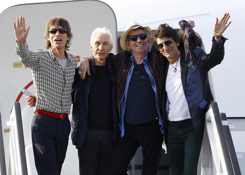 Mick Jagger, Charlie Watts, Keith Richards and Ronnie Wood of the Rolling Stones wave after landing in Havana, March 24, 2016. 