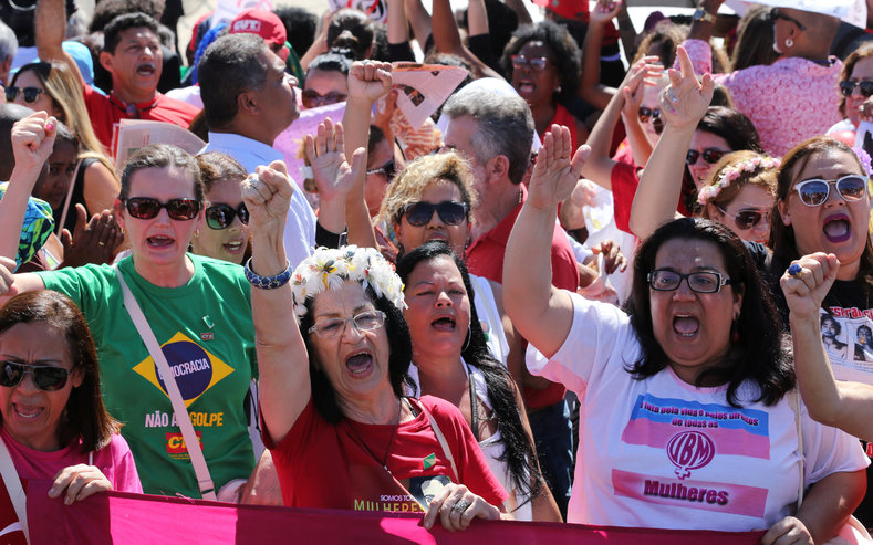 Supporters of suspended Brazilian President Dilma Rousseff shout slogans after the Brazilian Senate voted to impeach Rousseff for allegedly breaking budget laws, outside Planalto Palace in Brasilia